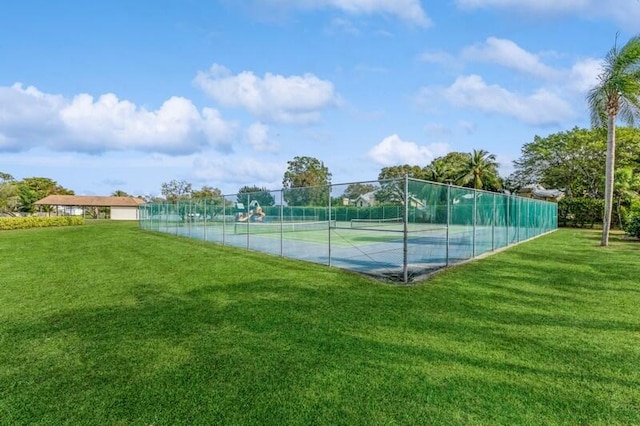 view of sport court featuring a lawn