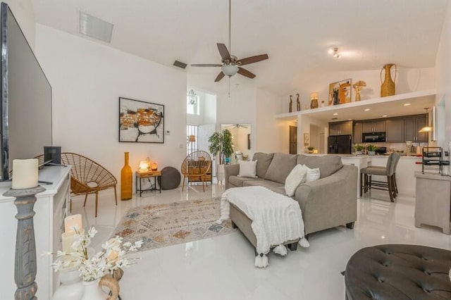 living room featuring ceiling fan and lofted ceiling