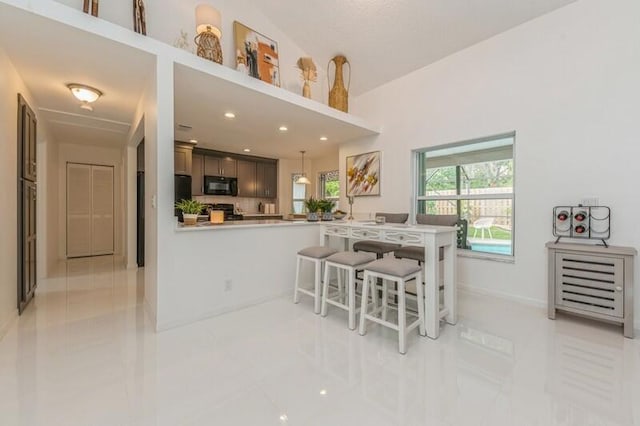 tiled dining room with lofted ceiling