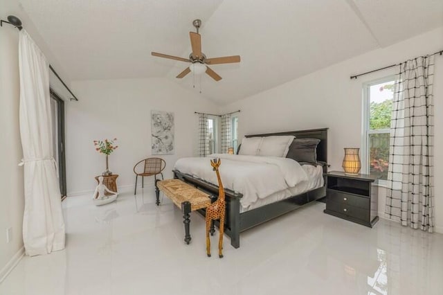 bedroom featuring ceiling fan, light tile patterned floors, and lofted ceiling