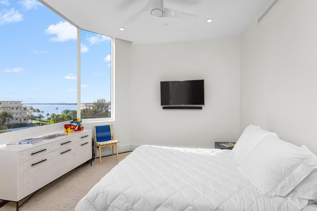 bedroom with ceiling fan and light colored carpet