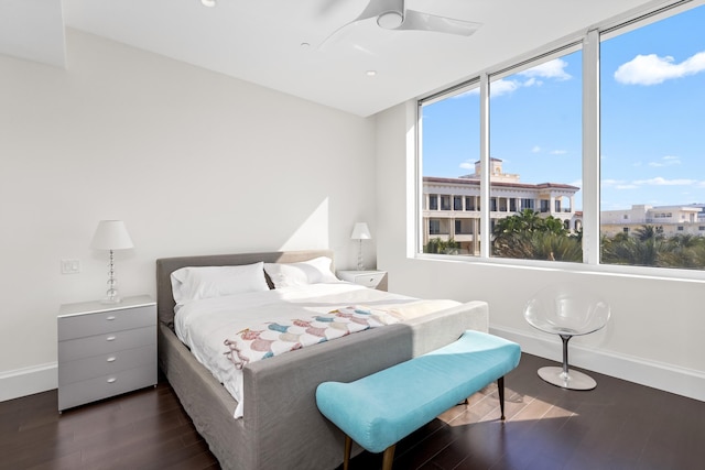 bedroom with dark hardwood / wood-style floors and ceiling fan