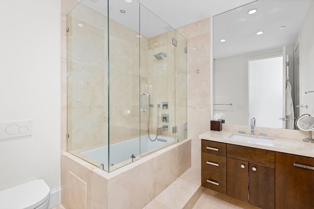 full bathroom featuring tile patterned floors, vanity, toilet, and bath / shower combo with glass door