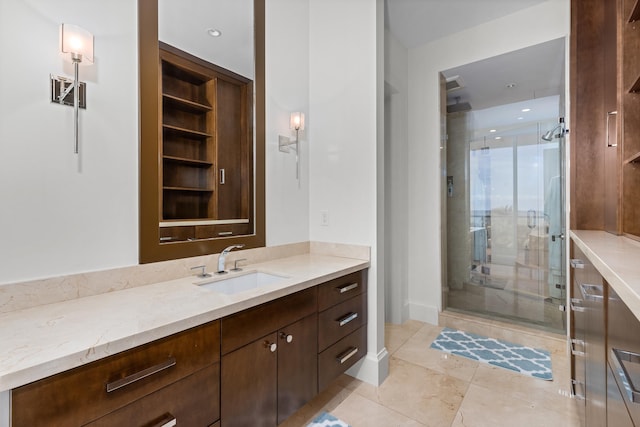 bathroom featuring tile patterned flooring, vanity, and an enclosed shower