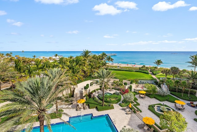 view of pool with a patio and a water view