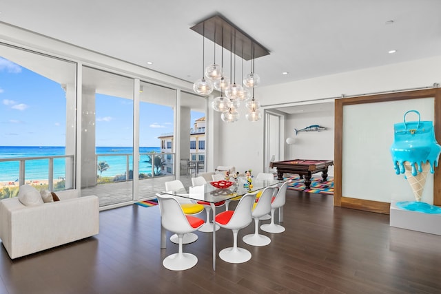 dining area with dark hardwood / wood-style floors, expansive windows, a water view, and billiards