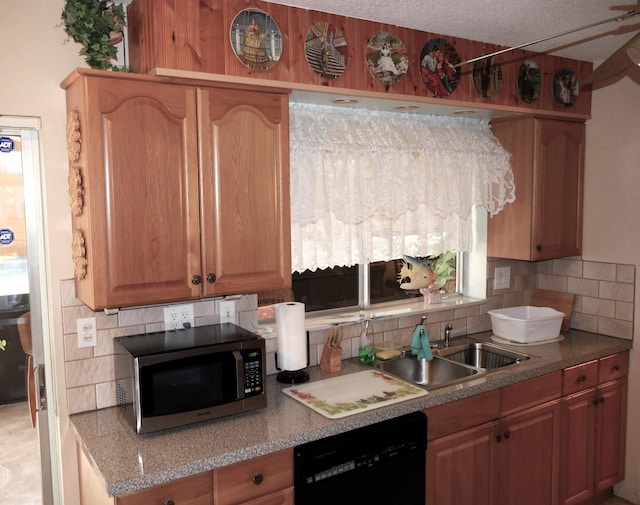 kitchen with tasteful backsplash, sink, black dishwasher, and a textured ceiling