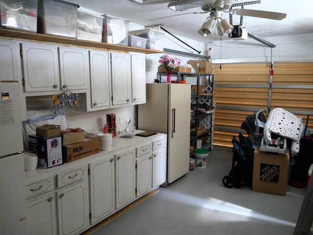 interior space with ceiling fan, white fridge, and a garage door opener