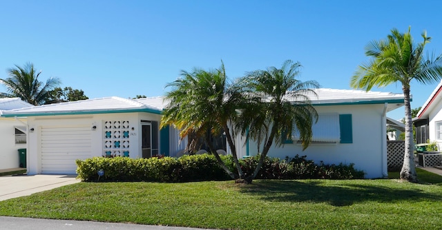 view of front facade with a front yard and a garage