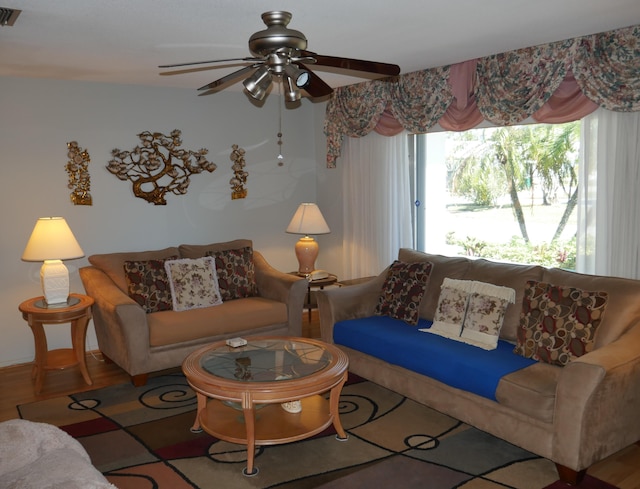 living room with ceiling fan and hardwood / wood-style floors