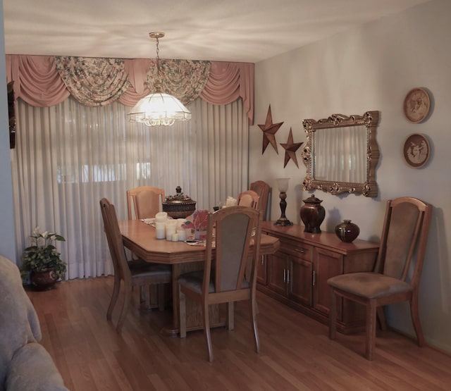 dining area with an inviting chandelier and hardwood / wood-style floors