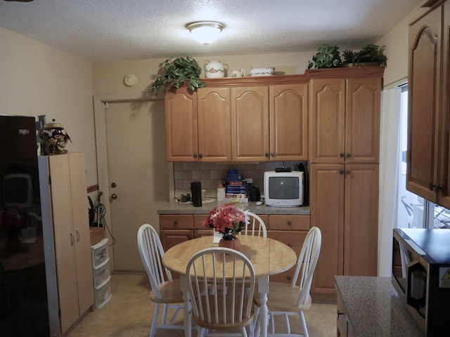 kitchen with backsplash and a textured ceiling