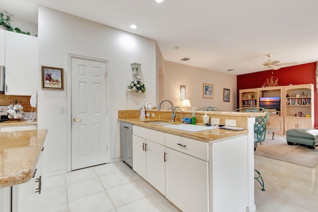 kitchen with ceiling fan, stainless steel dishwasher, kitchen peninsula, a breakfast bar, and white cabinets