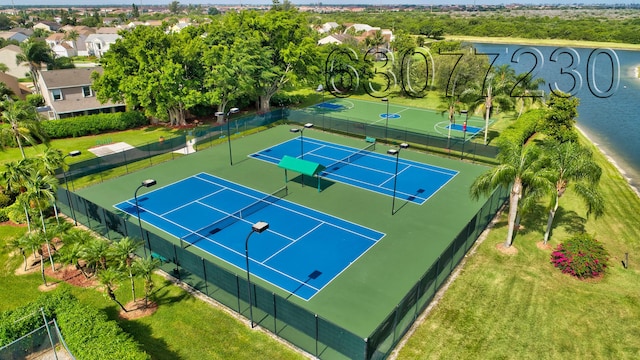 view of sport court featuring a yard