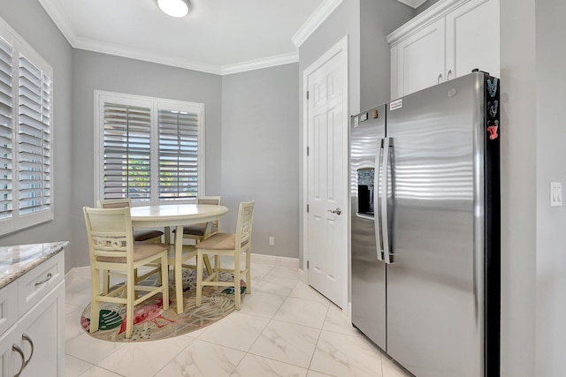 kitchen featuring stainless steel refrigerator with ice dispenser, ornamental molding, white cabinets, and light stone counters