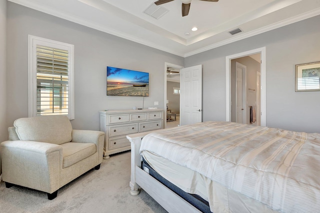 carpeted bedroom with a raised ceiling, crown molding, and ceiling fan