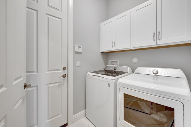 laundry room featuring cabinets and washing machine and dryer