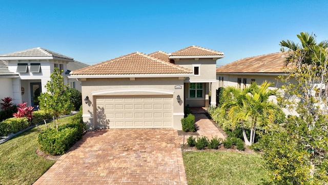 view of front facade featuring a garage and a front lawn