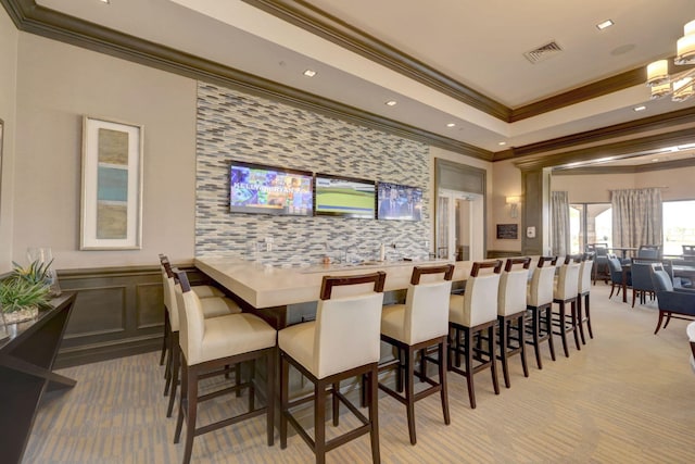 bar with ornamental molding and light colored carpet