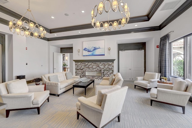 carpeted living room featuring a fireplace, ornamental molding, a tray ceiling, and a chandelier