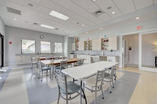 dining space with a drop ceiling