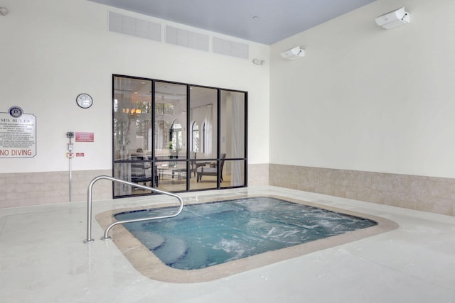 view of swimming pool with an indoor in ground hot tub