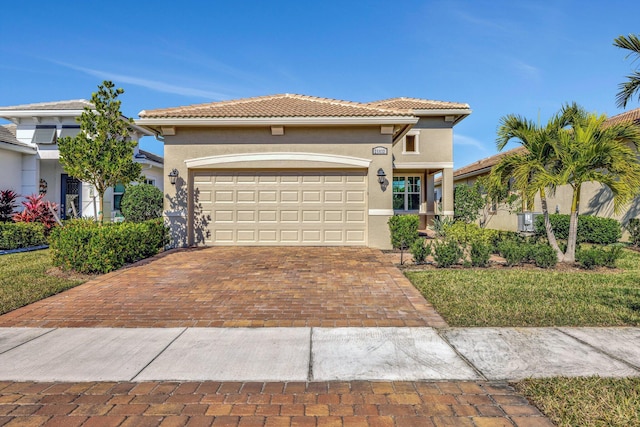 mediterranean / spanish-style home with a garage