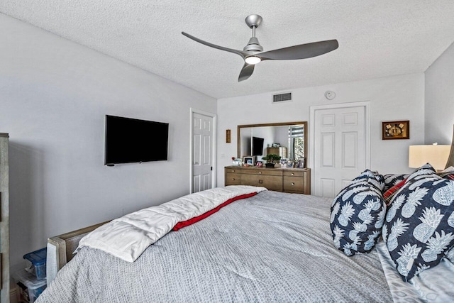 bedroom featuring a textured ceiling and ceiling fan