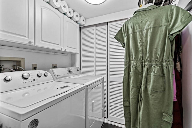 clothes washing area with cabinets and washer and clothes dryer