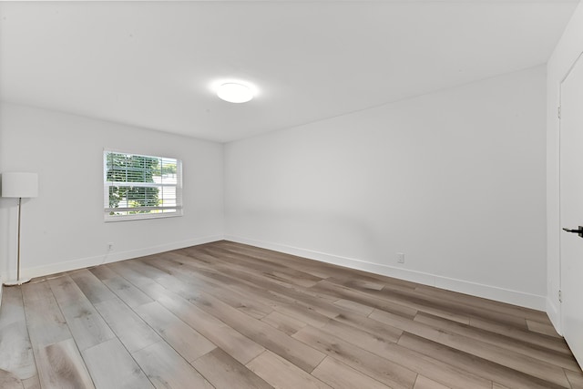 unfurnished room with light hardwood / wood-style floors