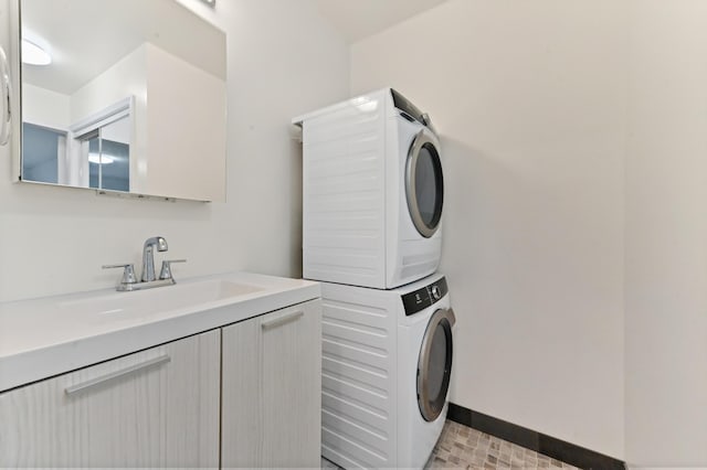 clothes washing area with sink and stacked washer and clothes dryer