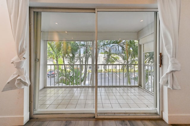 doorway to outside with plenty of natural light and hardwood / wood-style floors