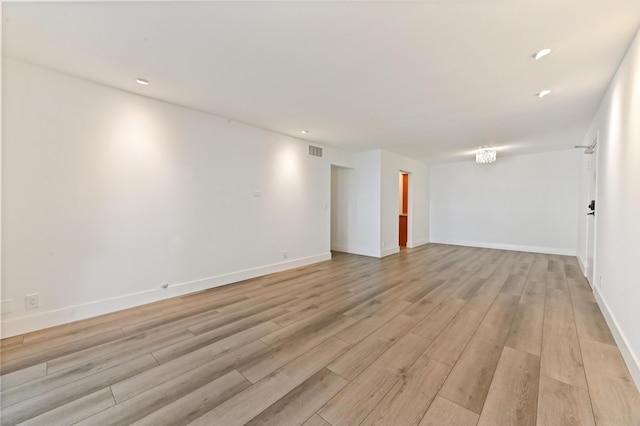 unfurnished room with light hardwood / wood-style floors