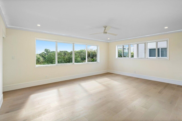 empty room with light hardwood / wood-style floors and ceiling fan