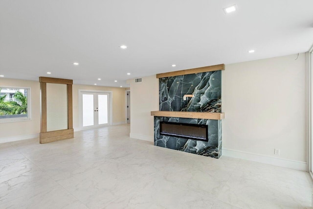 living room featuring a fireplace and french doors