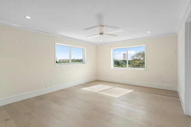 spare room with light hardwood / wood-style flooring, crown molding, plenty of natural light, and ceiling fan