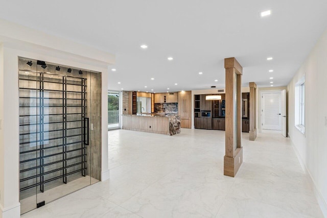 living room with sink and decorative columns