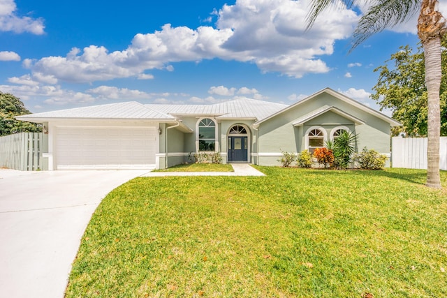 single story home with a garage and a front yard