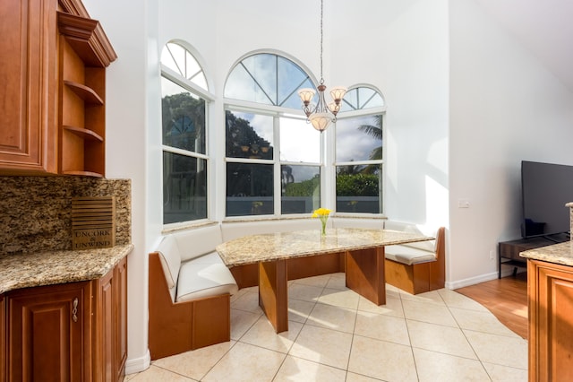 dining space with a notable chandelier and light tile patterned floors