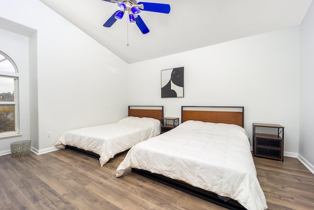bedroom featuring dark hardwood / wood-style floors, high vaulted ceiling, and ceiling fan