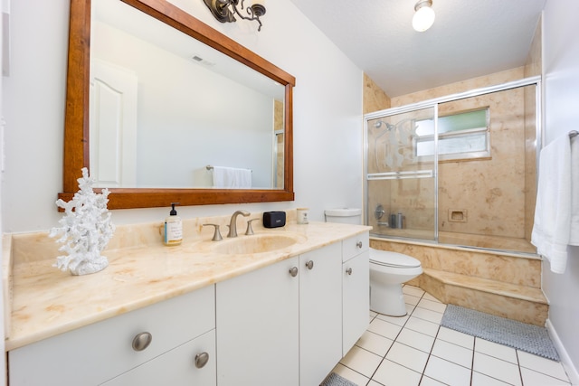 full bathroom featuring tile patterned flooring, toilet, vanity, and combined bath / shower with glass door