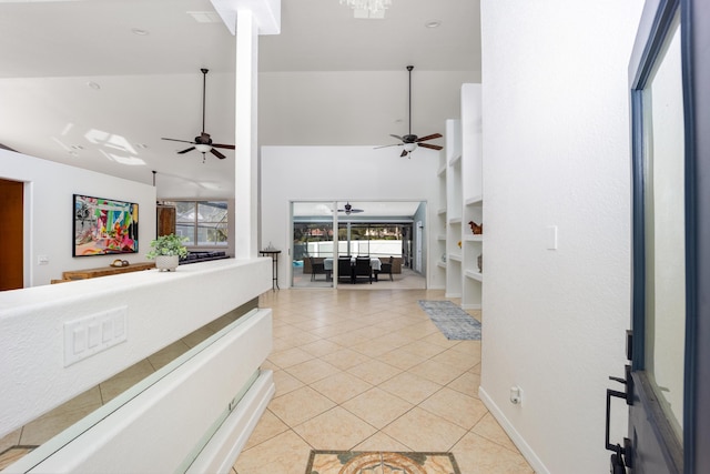 entrance foyer featuring light tile patterned floors, vaulted ceiling, and plenty of natural light