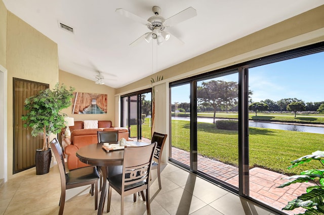 sunroom / solarium featuring vaulted ceiling, a water view, visible vents, and a ceiling fan