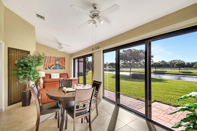 sunroom with a water view, ceiling fan, and lofted ceiling