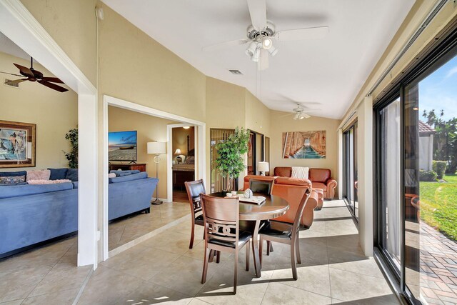 dining area featuring light tile patterned flooring, a healthy amount of sunlight, and lofted ceiling