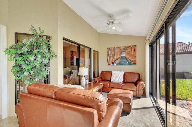 living room featuring ceiling fan, light tile patterned flooring, and vaulted ceiling