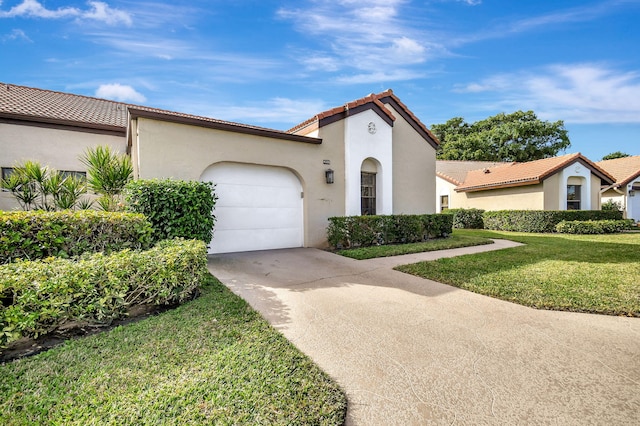 mediterranean / spanish-style home with a garage and a front yard