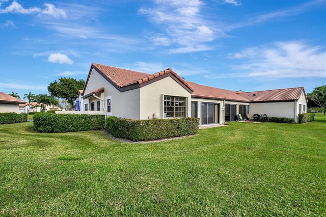 rear view of house with a lawn