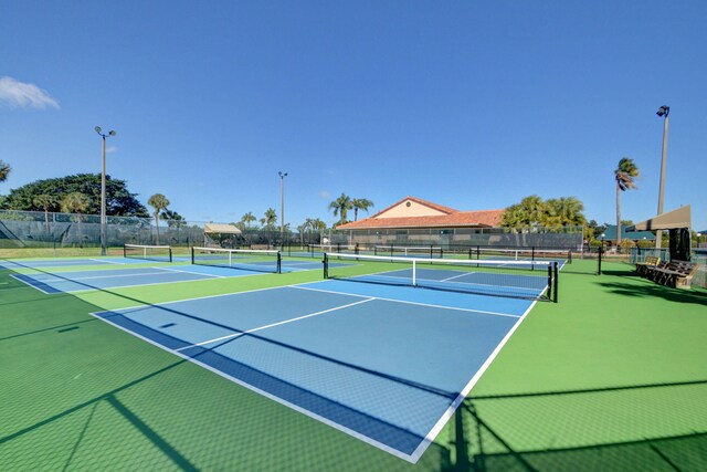 view of tennis court featuring basketball hoop