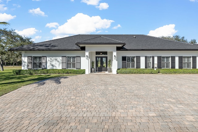 view of front facade featuring french doors and a front yard